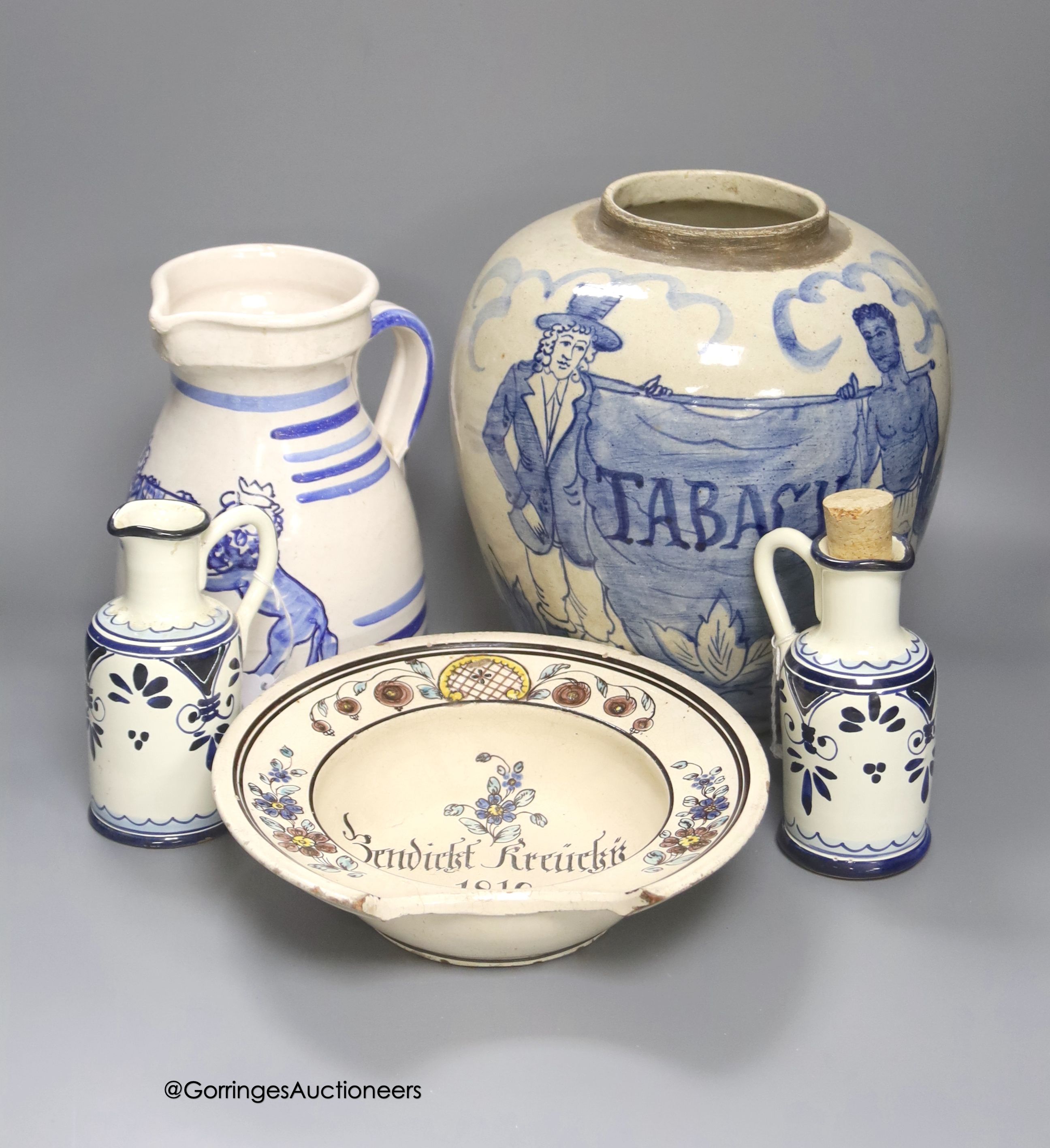 A tin-glazed terracotta barber's bowl dated 1819, a large ovoid eathenware ‘Taback’ jar and three earthenware jugs